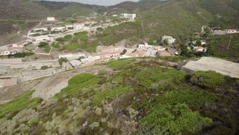 Aerial-orbit-over-the-abandoned-silver-mines-in-Argentiera,-Italy---bankruptcy,-financial-crisis,-end-of-the-industrial-era-in-Europe-concept