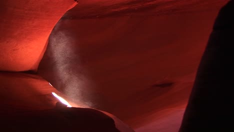 mediumshot of a light beam illuminating an interior space in antelope canyon arizona