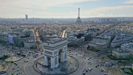 Triumphal-arch-or-Arc-de-Triomphe-with-Tour-Eiffel-in-background,-Paris-cityscape,-France