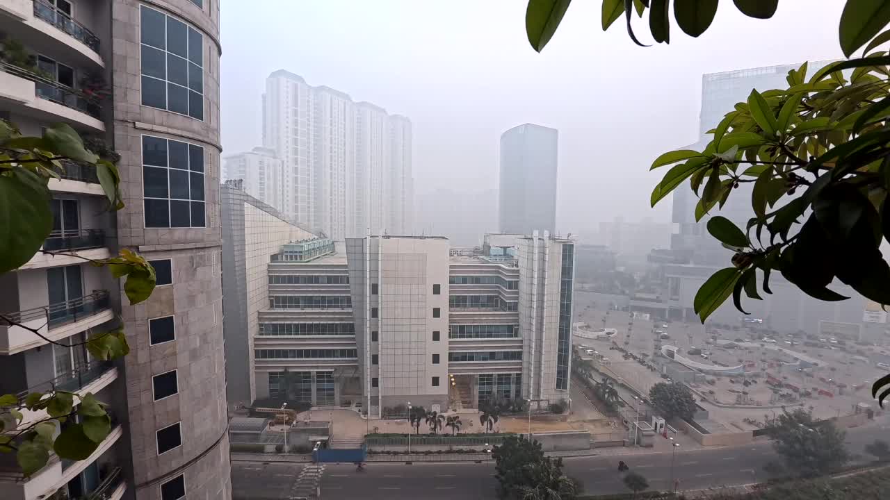 A balcony view of the smog and pollution in Gurgaon, India, from Pinnacle residence, looking over the American Express Building.