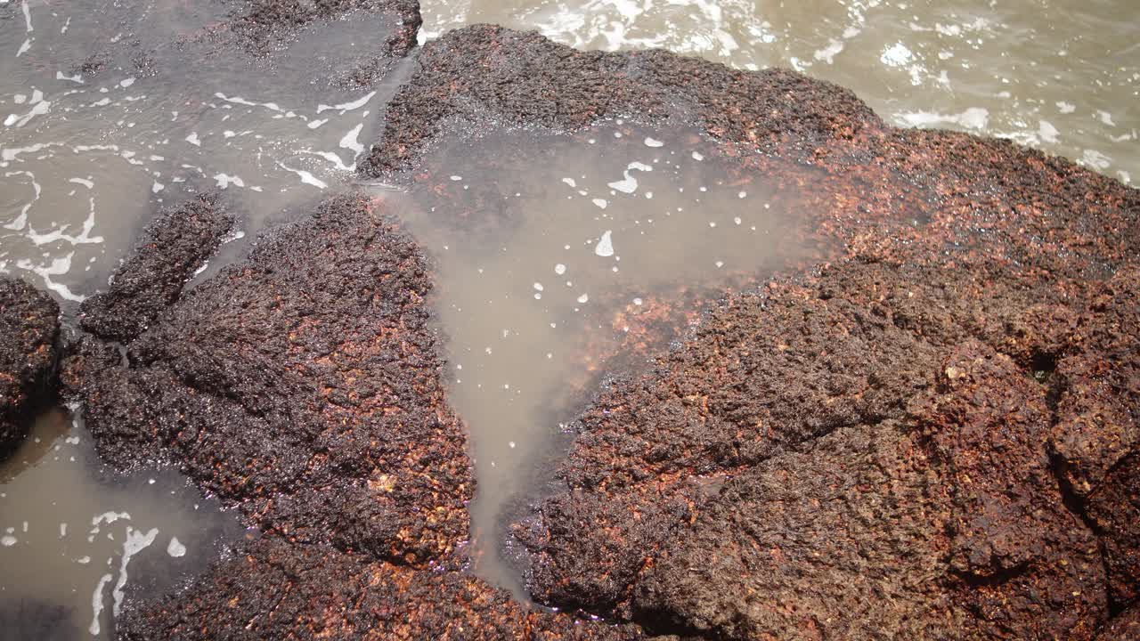 Static close-up of seawater trapped between rugged coastal rocks