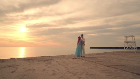 couple kissing on sea beach at sunset. love couple hugging on beach