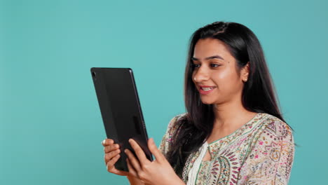 Woman-having-friendly-discussion-during-teleconference-meeting-using-tablet