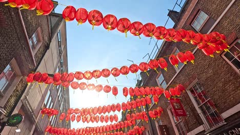 red lanterns hanging between buildings in london