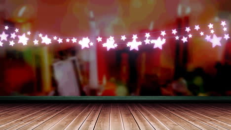 decoración de luz de hadas en forma de estrella rosada brillante colgando sobre una tabla de madera