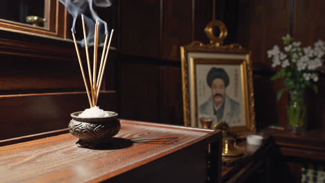 incense and portrait in a traditional shrine