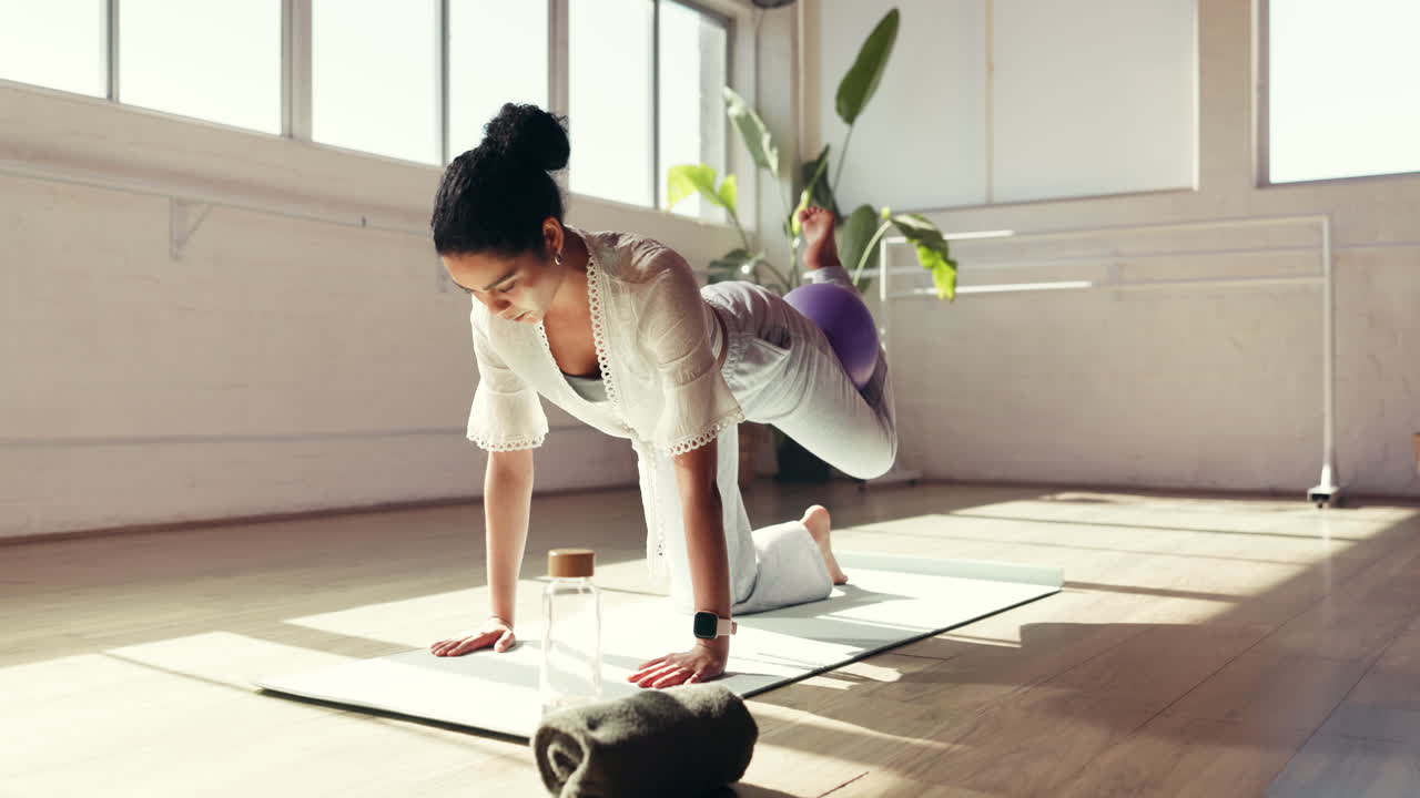 Woman doing yoga at home with balance ball