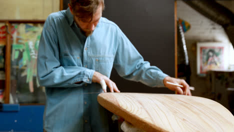 man making surfboard 4k