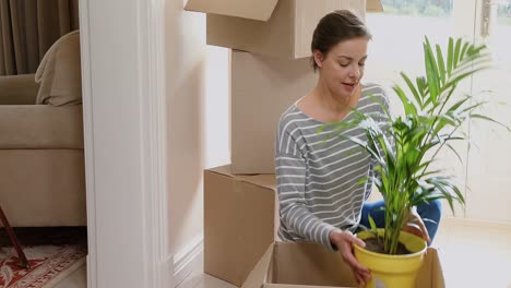 Woman-unpacking-cardboard-box-4K-4k