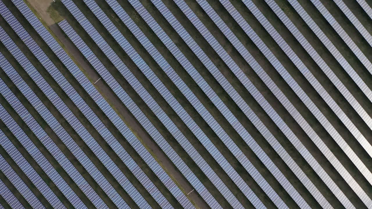 Aerial drone view into large solar panels at a solar farm. Solar cell power plants. footage video 4k.