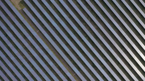aerial drone view into large solar panels at a solar farm. solar cell power plants. footage video 4k.
