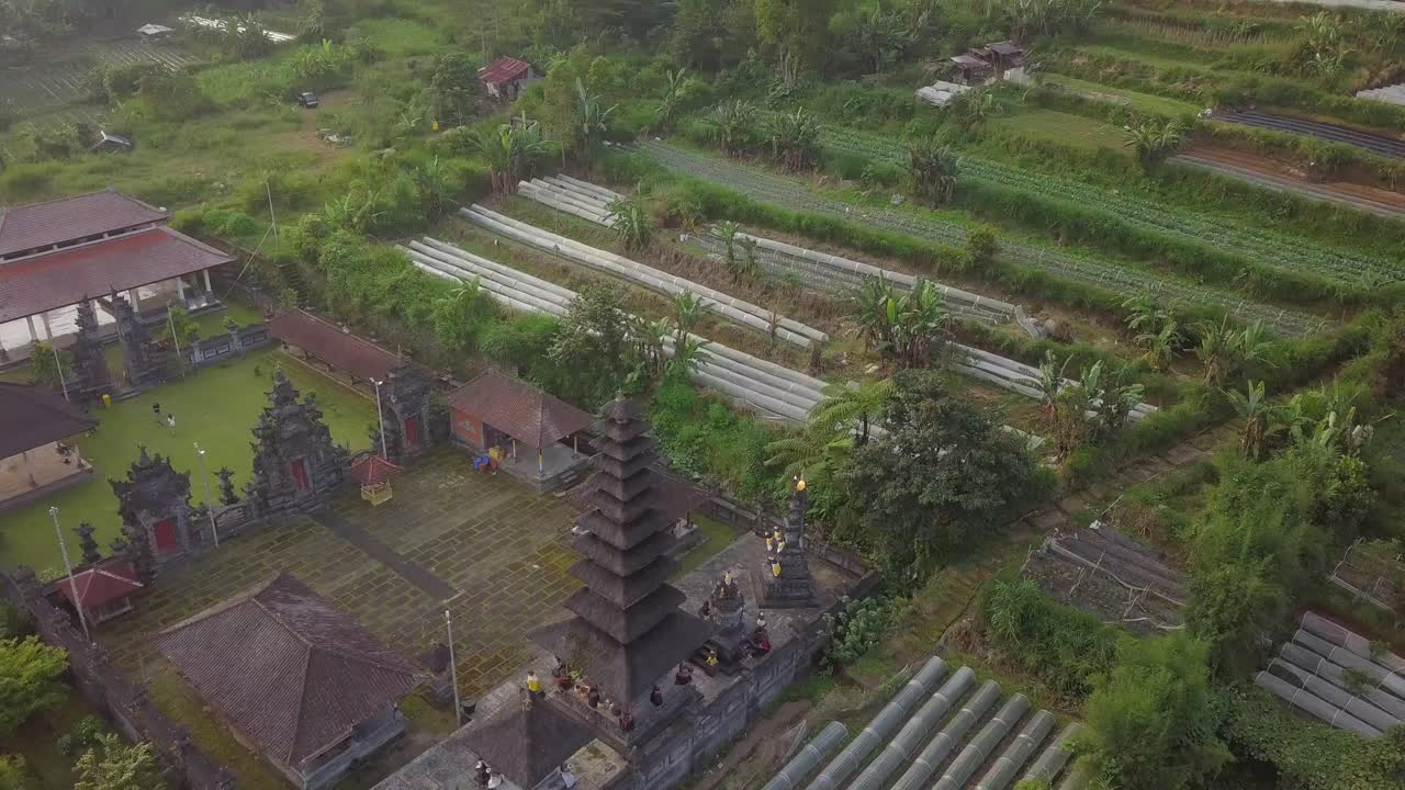 Bali Attractions and landmarks in 4k drone. Ancient temple in Bali surrounded by nature farm land