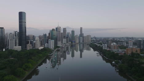 cinematic drone flying away from brisbane city and gardens