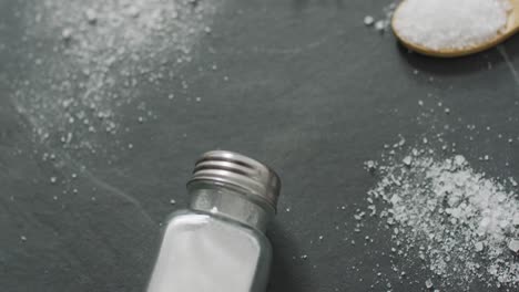 video of salt in a salt shaker on stone kitchen worktop