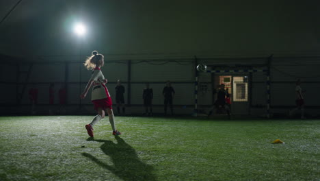 young woman soccer player training indoor