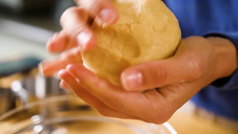 close-up-hands-kneading-a-dough-into-a-ball