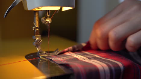 woman sewing medical masks on sewing machine during coronavirus pandemic