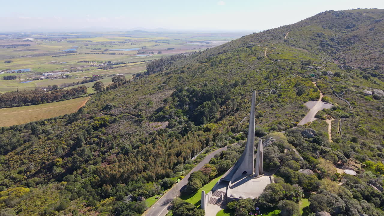 Afrikaanse Taalmonument atop Paarl mountain overlooking farm land countryside