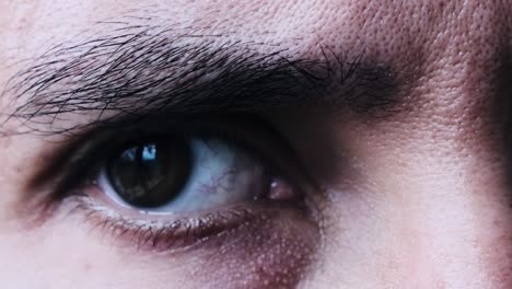 Eurasian-man's-eye-looking-worried,-close-up-shot