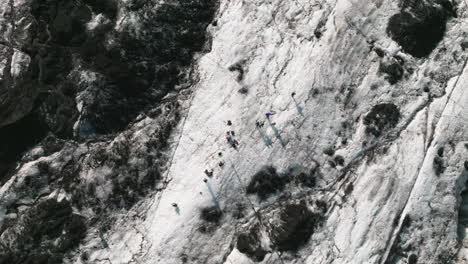 bird's eye view of photographers on surface icelandic glacier