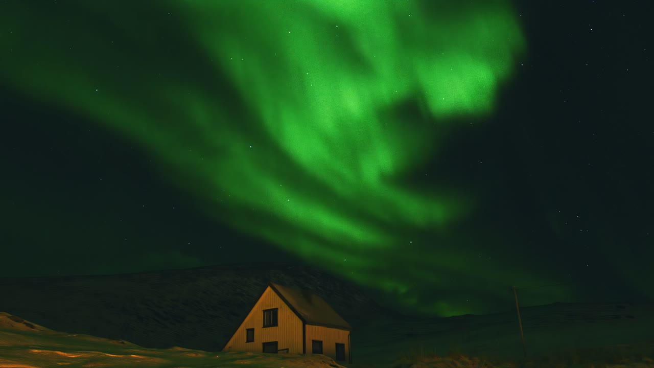 Time lapse of Northern Lights over a Single House, Norway in night.
