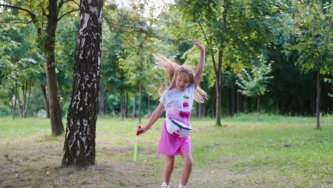 little girl with soap bubbles. young beautiful girl blowing bubbles outdoors
