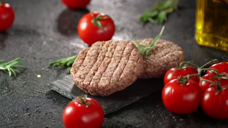 raw beef burger on a stone board rotates.