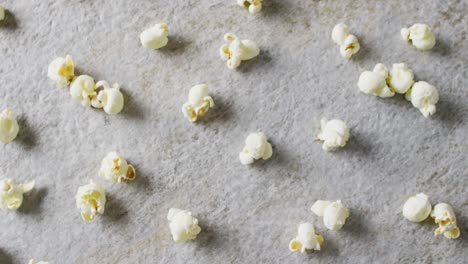 video of close up of popcorn on gray background