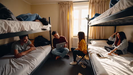 students hanging out in a dorm room with bunk beds