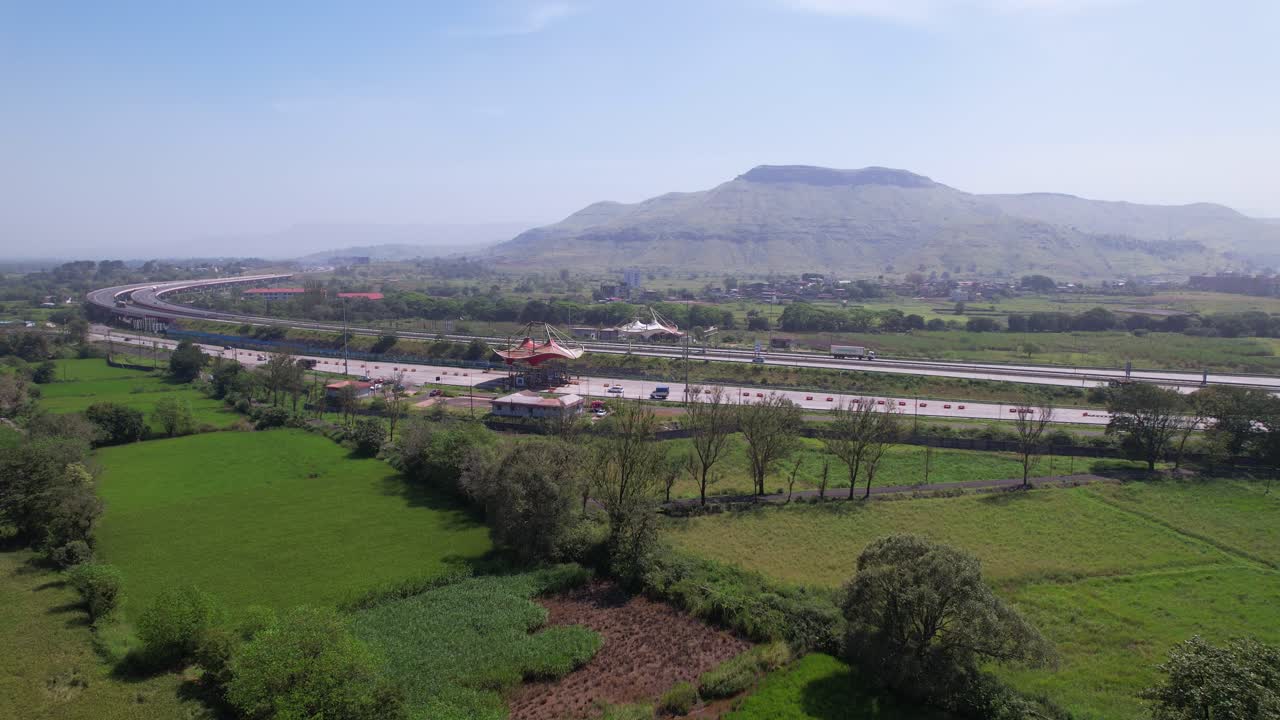 Rice paddy field near Samruddhi Mahamarg, Mumbai Nagpur expressway, Western Ghats mountains, Maharashtra