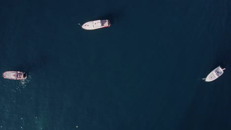 aerial drone shot top down view looking down at anchored boats in positano, italy