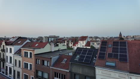 rooftop solar panels on brussels buildings during sunset