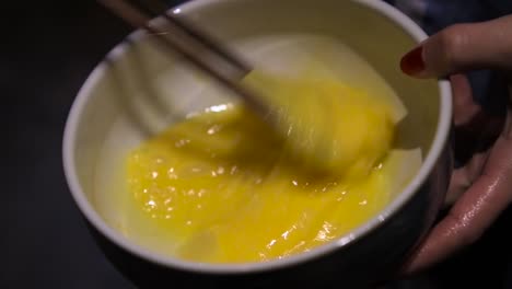 slow motion video mixing an egg