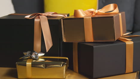 close up of gift wrapped presents on table in lounge at home 1