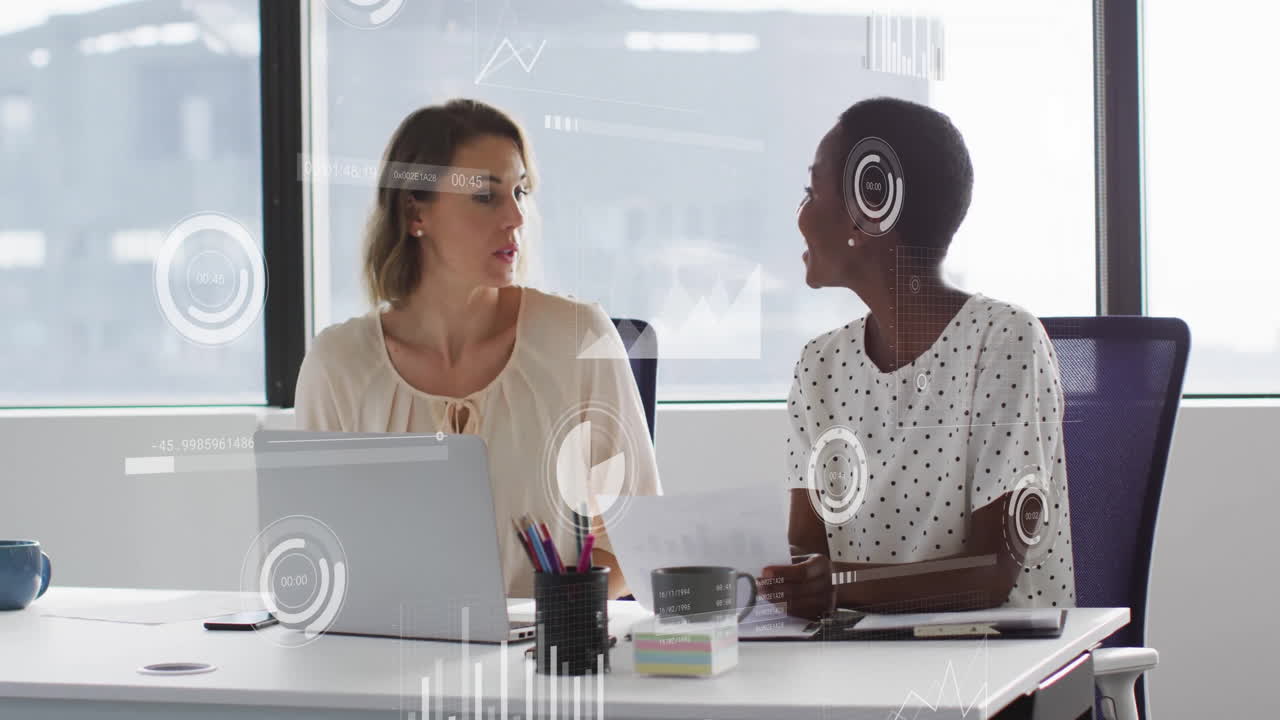 Animation of data processing and diagrams over diverse female colleagues discussing work in office
