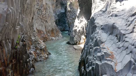 flying inside alcantara river gore in sicily without people, drone flying backwards