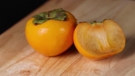 close-up of a persimmon and its slice