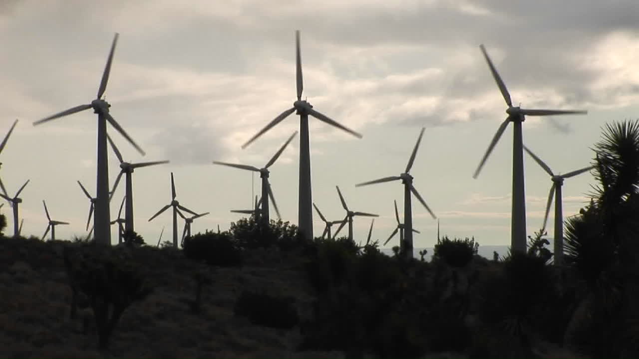 molino de viento retroiluminado genera energía eléctrica en una ladera en california 3
