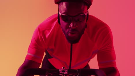 video of focused african american male cyclist riding on neon orange lightning