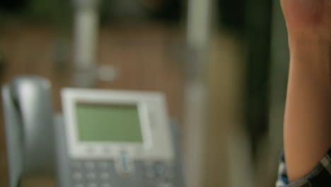 side shot of a man grabbing his phone and answering a call