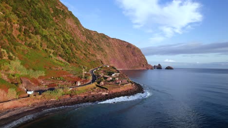 Aerial-view-along-volcanic-red-coast-on-a-beautiful-sunny-day,-Madeira