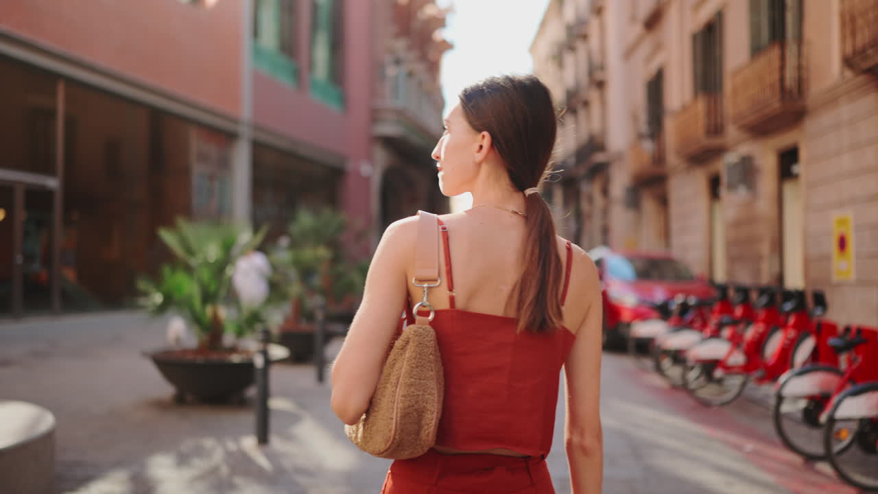 A woman walks down a city street