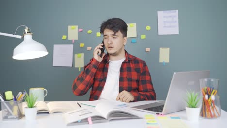 male student speaking angrily on the phone.