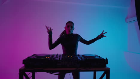 woman dj mixing music in a studio with neon lights