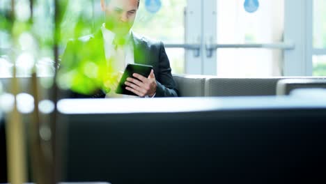 portrait male caucasian finance executive using tablet technology