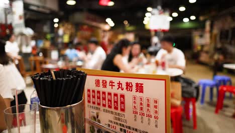 people enjoying food at a bustling restaurant