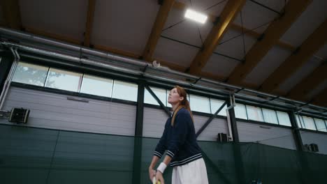 woman playing tennis indoor