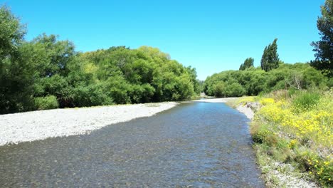 low aerial reverse above beautiful selwyn river at chamberlains ford in summertime