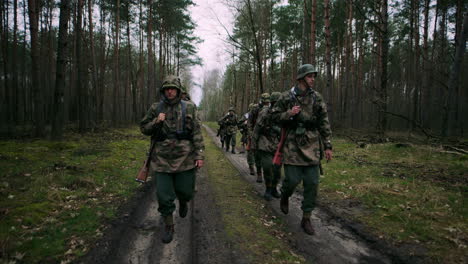 wwii soldiers marching through forest
