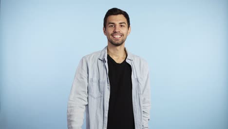 Happy-man-shows-thumb-up,-joyful-man-smiling-to-the-camera.-Cheerful-brunette-guy,-successful-guy-giving-thumb-up-successful-thumb-up-yes-ok-concept-caucasian-adult-man-model-on-the-blue-background